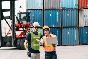 Team Engineer and worker wear safety uniform check control loading freight cargo container use computer laptop at commercial dock warehouse,transportation import,export logistic industrial service photo