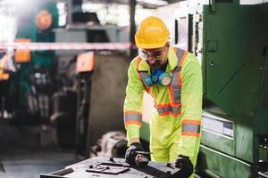 Factory worker man wearing safety protection with in gloves to prepare for work sheet metal nibbler cutter photo