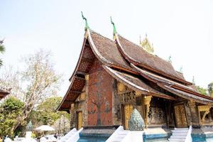 LUANG PRABANG , LAOS -FEB 26 2023 Wat Xieng Thong is one of the largest temples in Luang Prabang. A symbol of great historic importance, its structure has characteristics of 16th-century photo