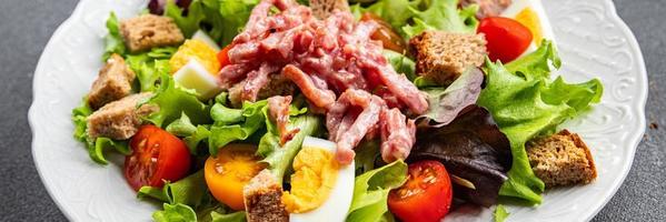Vosges green salad, egg, bacon salad, crouton, lettuce, salad dressing vinaigrette Lorraine cuisine meal food snack on the table copy space food background rustic top view photo