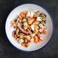 seafood salad shrimp, mussel, scallop, octopus meal food snack on the table copy space food background rustic top view photo