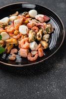 seafood salad shrimp, mussel, scallop, octopus meal food snack on the table copy space food background rustic top view photo