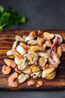 seafood salad shrimp, mussel, scallop, octopus meal food snack on the table copy space food background rustic top view photo