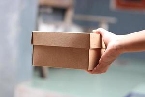 empty brown cardboard photo held in hand