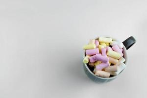 the cup is photographed from above. Multicolored marshmallows in a cup photo