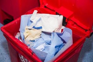 Biological risk waste disposed of in the red trash bag at a operating room in a hospital. Sign showing the biological hazard symbol. photo