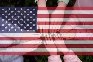 Hands of kids on background of USA flag. American patriotism and unity concept. photo