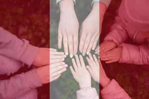Hands of kids on background of Peru flag. Peruvian patriotism and unity concept. photo