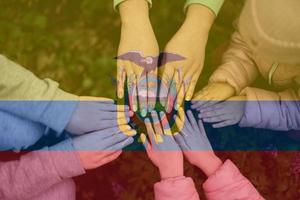 Hands of kids on background of Ecuador flag. Ecuadorian patriotism and unity concept. photo