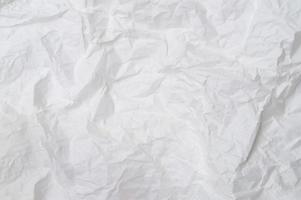 Wrinkled or crumpled white stencil paper or tissue after use in toilet or restroom with large copy space used for background texture in art work photo