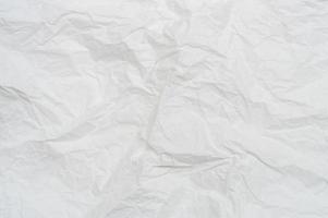Wrinkled or crumpled white stencil paper or tissue after use in toilet or restroom with large copy space used for background texture in decorative art work photo