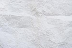 Wrinkled or crumpled white stencil paper or tissue used for background texture photo