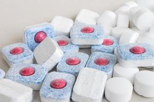 Chemical tablets for the dishwasher. Colored capsules are dishwasher safe. photo