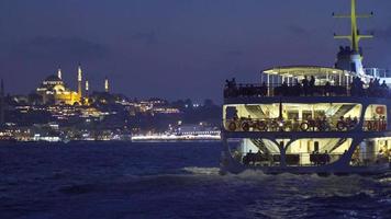 Night sea view of ferry and mosque. Sea view of mosque and ferry in the city. Istanbul city of Turkey. video