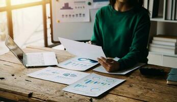 Financial analysts analyze business financial reports on a digital tablet planning investment project during a discussion at a meeting of corporate showing the results of their successful teamwork. photo