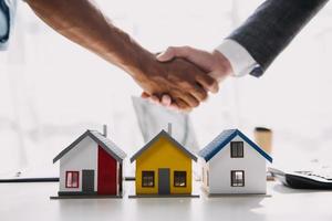 Female woman hands holding home model, small miniature white toy house. Mortgage property insurance dream moving home and real estate concept photo