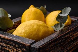 Delicious fresh yellow citrus fruits or lemon in a wooden box photo