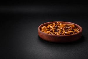 Delicious noodles or udon with mushrooms, salt, spices and herbs photo