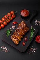 Delicious grilled pork ribs with sauce, spices and herbs photo