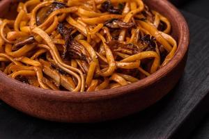 Delicious noodles or udon with mushrooms, salt, spices and herbs photo