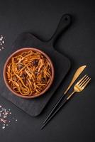 Delicious noodles or udon with mushrooms, salt, spices and herbs photo