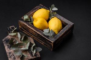 Delicious fresh yellow citrus fruits or lemon in a wooden box photo