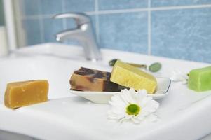 Craft organic soap bars on washbasin in the home bathroom. Purity. Hygiene. Home spa. Skin and body care concept photo