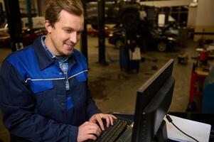 A technician, garage mechanic conducting diagnostic check of a car during regular warranty maintenance in auto service photo