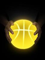 Basketball ball bright yellow neon lights in male hands photo