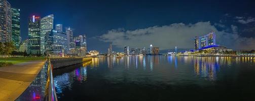 ver terminado centro de deportes acuáticos bahía en Singapur Durnig puesta de sol con ligero luces en agua foto