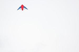 Colorful Kite shaped like birds is blowing on white sky photo