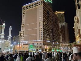 Mecca, Saudi Arabia, April 2023 - A beautiful view of pilgrims, tall buildings and lights at night on the outer road in Masjid al-Haram, Mecca. photo