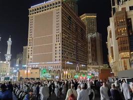 Mecca, Saudi Arabia, April 2023 - A beautiful view of pilgrims, tall buildings and lights at night on the outer road in Masjid al-Haram, Mecca. photo