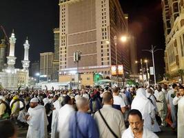 Mecca, Saudi Arabia, April 2023 - A beautiful view of pilgrims, tall buildings and lights at night on the outer road in Masjid al-Haram, Mecca. photo
