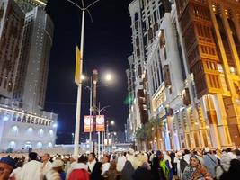 Mecca, Saudi Arabia, April 2023 - A beautiful view of pilgrims, tall buildings and lights at night on the outer road in Masjid al-Haram, Mecca. photo