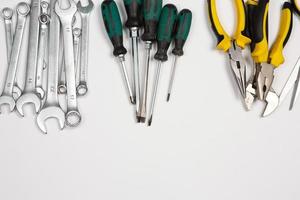 Set of tools for repair in a case on a white background. Assorted work or construction tools. Wrenches, Pliers, screwdriver. Top view photo