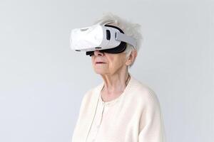 Old woman using virtual reality headset. VR gadgets, , education online or game concept. photo