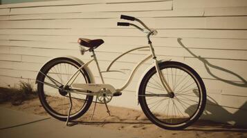 A beach cruiser bike leaning against a wall. photo