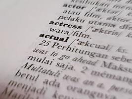 a close up of the word actual in the English to Indonesian dictionary. For language background or wallpaper photo