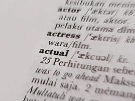 a close up of the word actual in the English to Indonesian dictionary. For language background or wallpaper photo