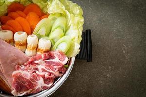 sukiyaki or shabu hot pot black soup with meat raw and vegetable photo