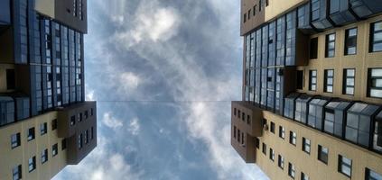 Modern skyscrapers raising to the sky. Cloudy blue sky. photo