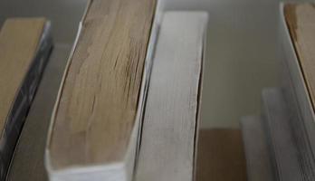 Old books row background. Old fashioned books closeup. photo