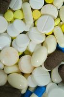 Multicolored pills texture. Pills closeup. Medicine theme texture. Health theme background. photo