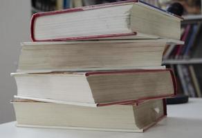 Old dirty books on the table. Books blurred background. photo