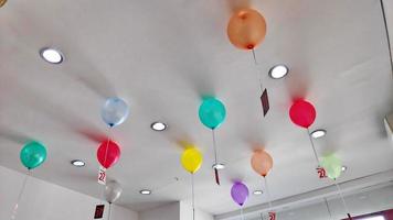 Beautiful colored air balloons hanging on the ceiling photo