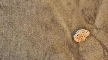 Beach sand pile with rocks for background and texture photo