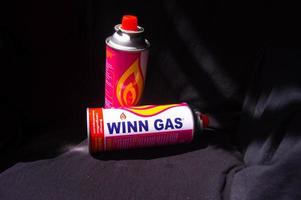 gresik, indonesia, 2022 - mini gas cans for portable stoves with black background photo