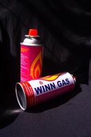 gresik, indonesia, 2022 - mini gas cans for portable stoves with black background photo