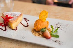 Delicius dessert for sharing. Cheese cake and orange ice cream photo